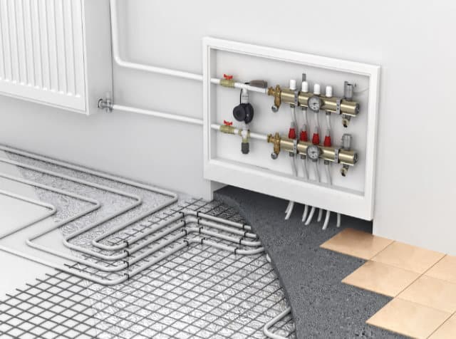 A cutaway view showing a radiant floor heating system with pipes beneath a tiled floor, expertly installed by Regina plumbing services and connected to a control panel mounted on the wall.